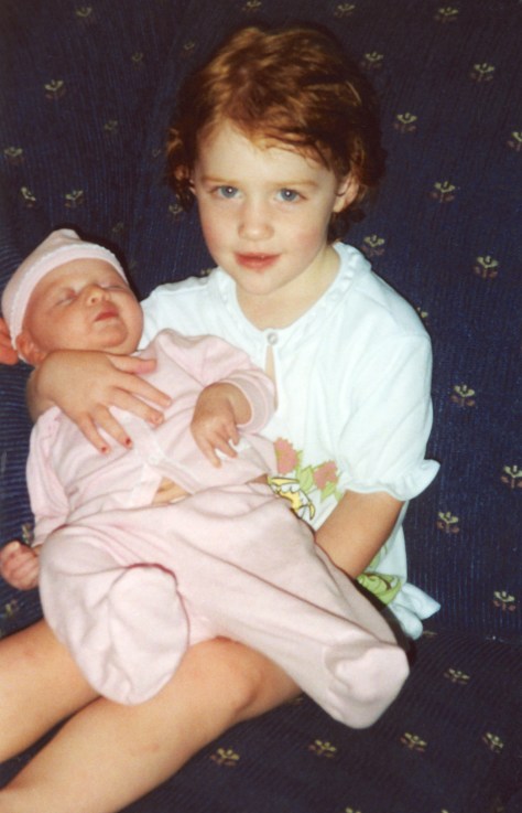 Samantha holds baby sister Ruby in July 1999.