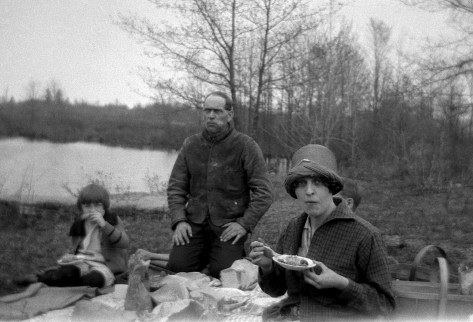 The Treutel family enjoys a picnic lunch on their property along the Hemlock Creek, circa 1924.