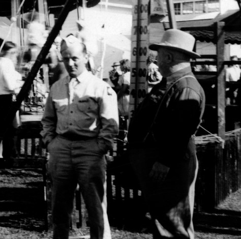 Army Pvt. Rudolph Mika (at left) of Mauston, Wis., talks to livestock buyer John Randall at the Juneau County Fair at Mauston in the summer of 1942.