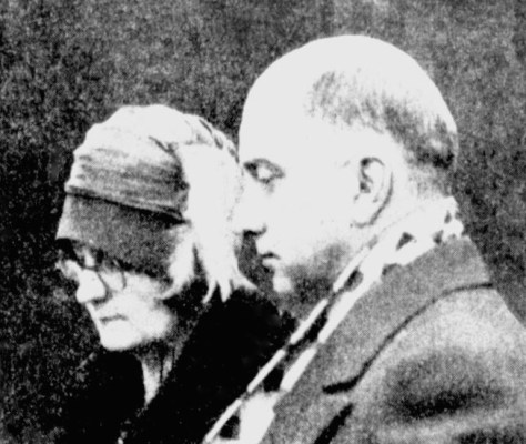 Alice and Harry Leng watch in stunned silence as the casket of their only child is blessed for burial.