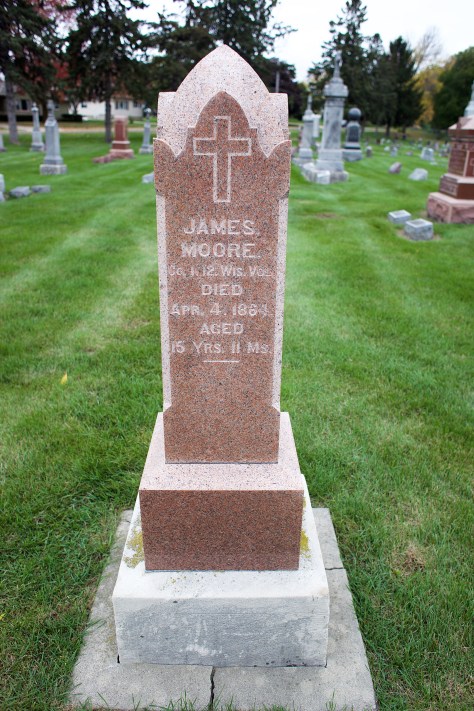 The grave marker of James Moore at Sacred Hearts of Jesus and Mary Catholic Cemetery in Sun Prairie, Wisconsin.
