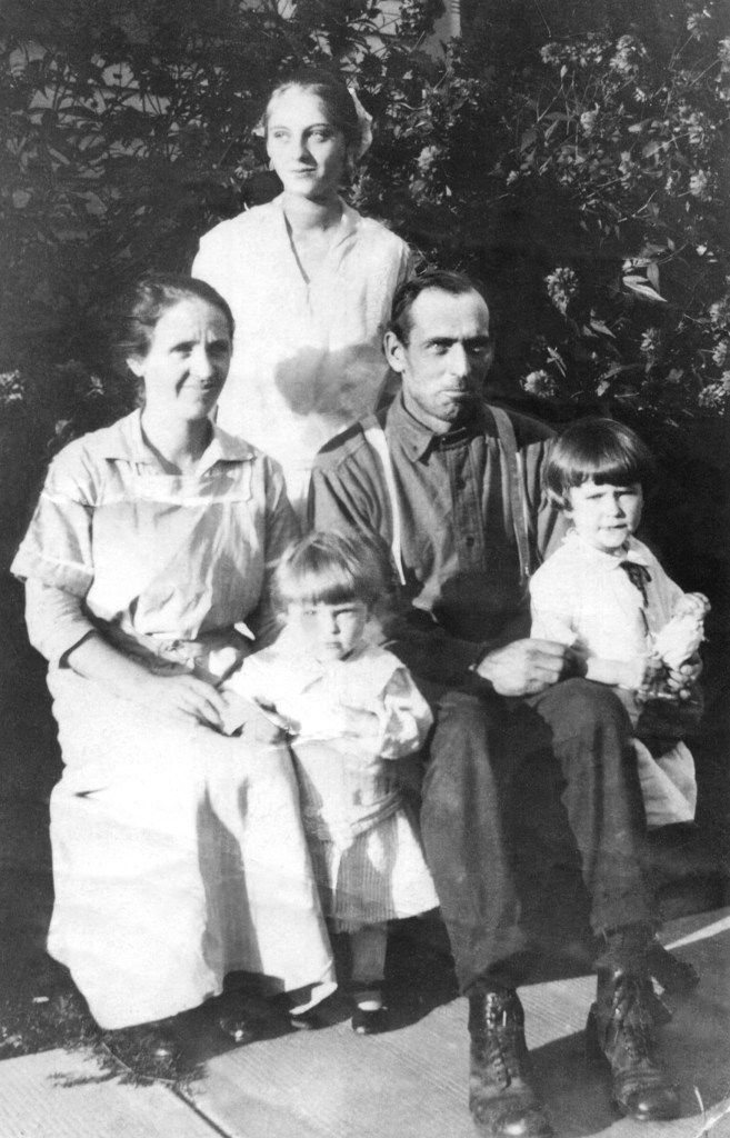 The uncropped version of the photo shows Ruby V. Treutel standing at rear. Mary and Walter Treutel are seated. In front are Marvin and Nina Treutel.