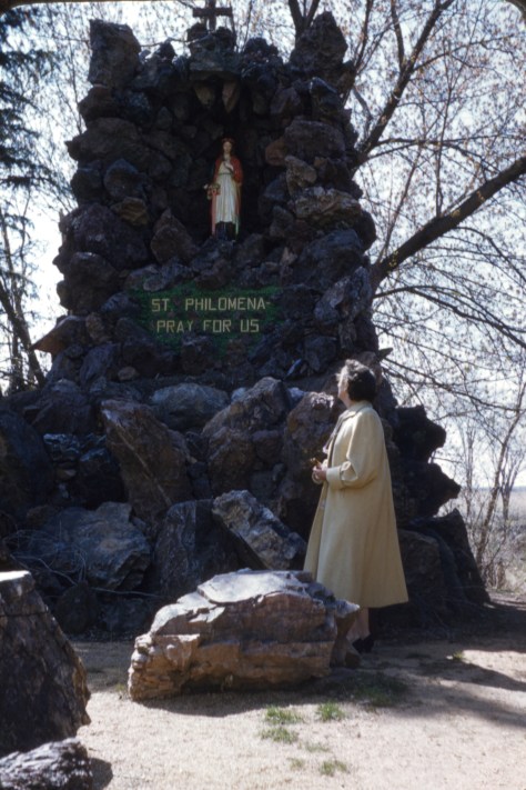 Ruby V. Hanneman stands at the St. Philomena shrine in Rudolph in the late 1950s.